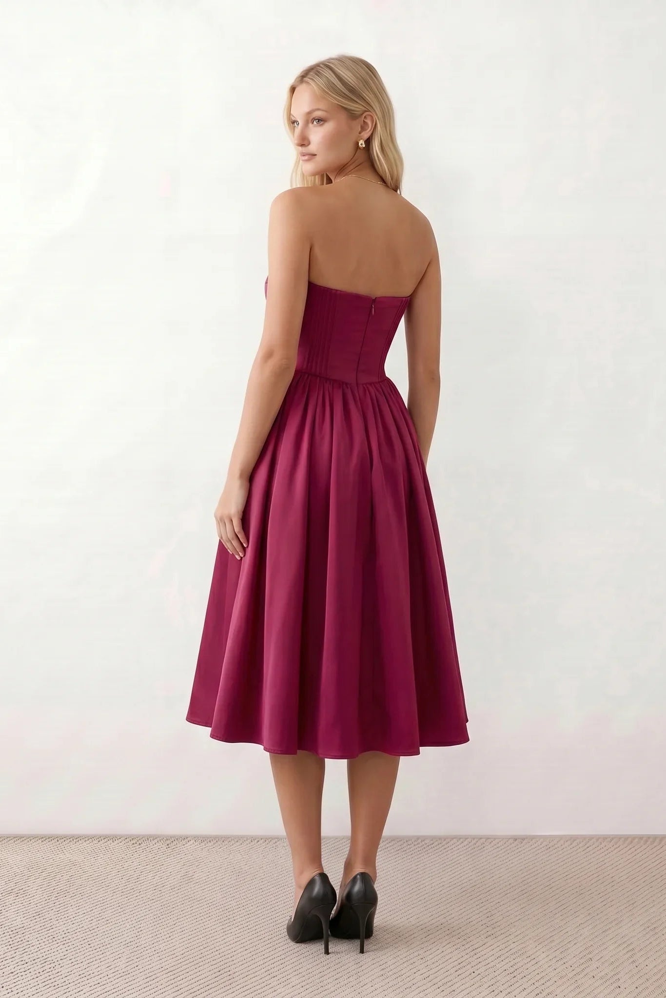 Women's strapless corset midi dress with a structured sweetheart neckline, boned bodice, pintuck basque waist and full pleated A-line skirt, elegant wedding guest and occasion dress.