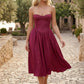 Women's strapless corset midi dress with a structured sweetheart neckline, boned bodice, pintuck basque waist and full pleated A-line skirt, elegant wedding guest and occasion dress.
