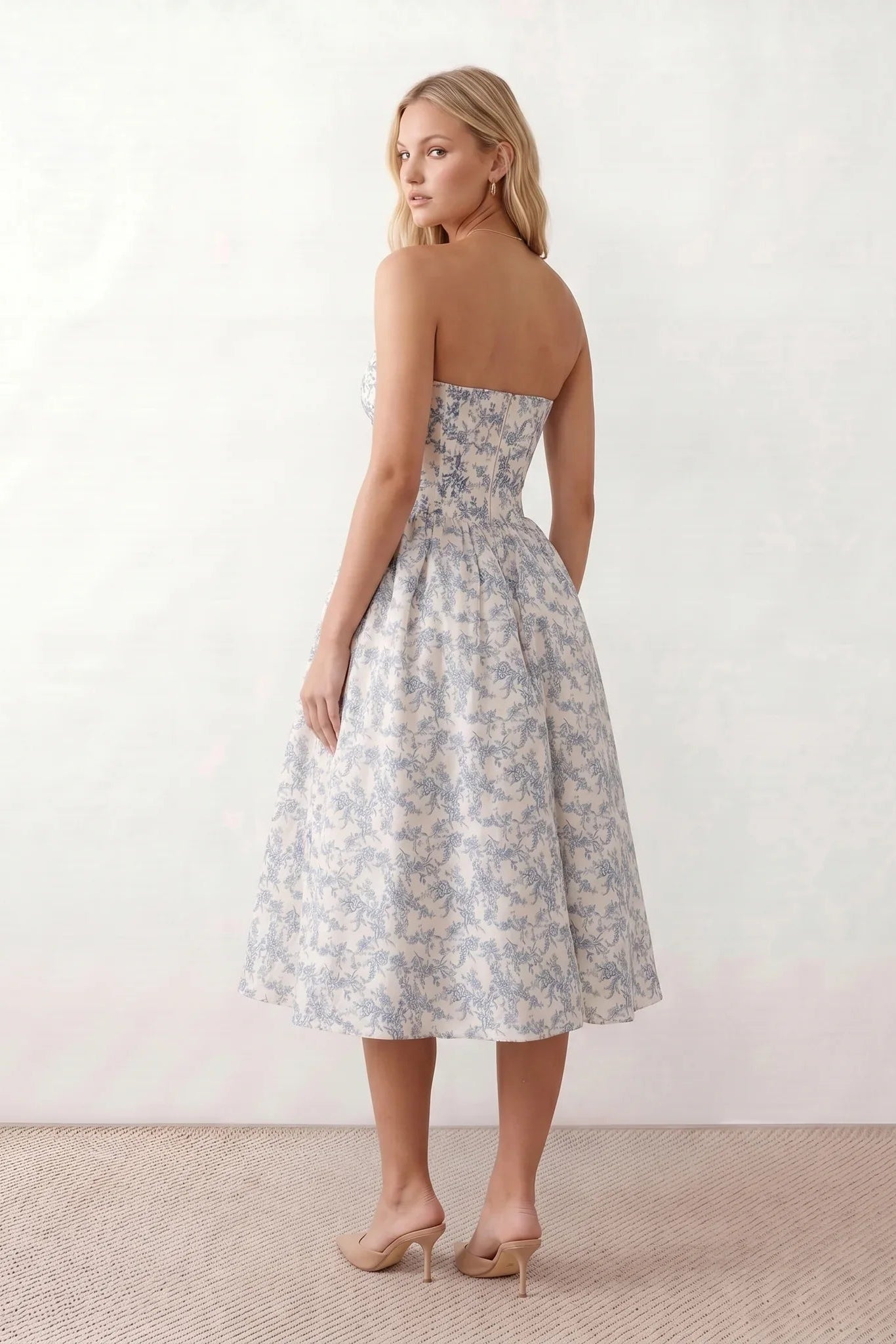 Women's strapless corset midi dress with a structured sweetheart neckline, boned bodice, pintuck basque waist and full pleated A-line skirt, elegant wedding guest and occasion dress.