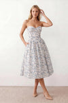 Women's strapless corset midi dress with a structured sweetheart neckline, boned bodice, pintuck basque waist and full pleated A-line skirt, elegant wedding guest and occasion dress.