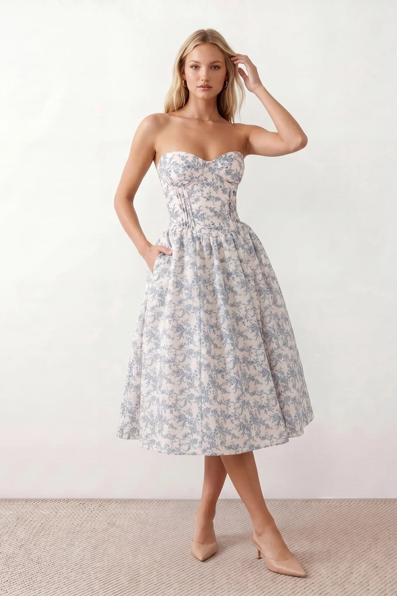 Women's strapless corset midi dress with a structured sweetheart neckline, boned bodice, pintuck basque waist and full pleated A-line skirt, elegant wedding guest and occasion dress.