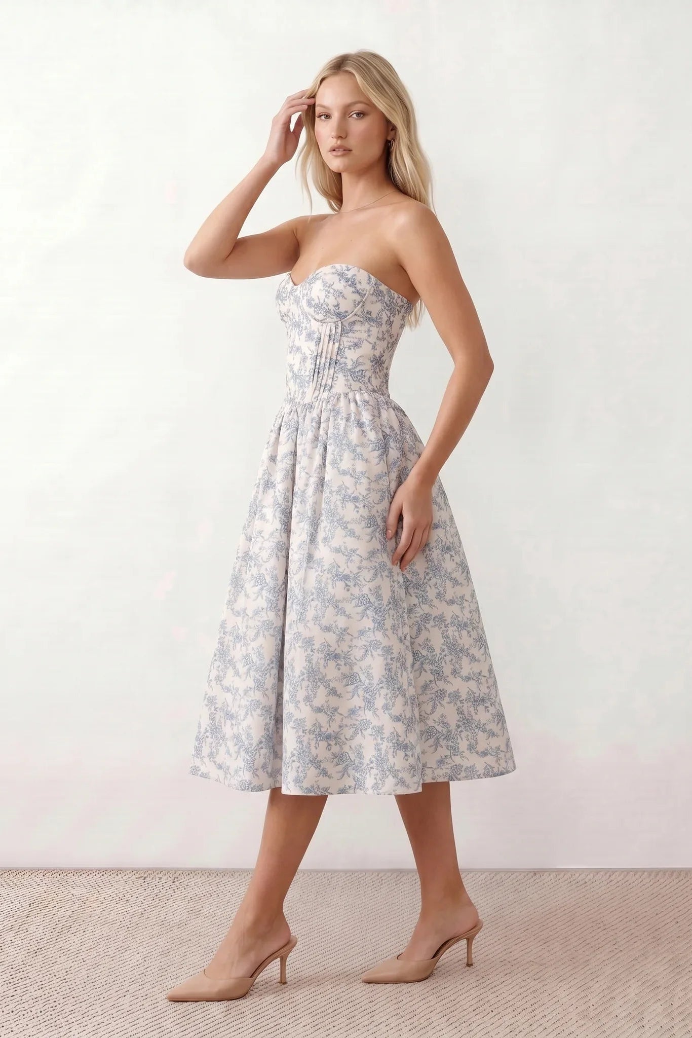Women's strapless corset midi dress with a structured sweetheart neckline, boned bodice, pintuck basque waist and full pleated A-line skirt, elegant wedding guest and occasion dress.