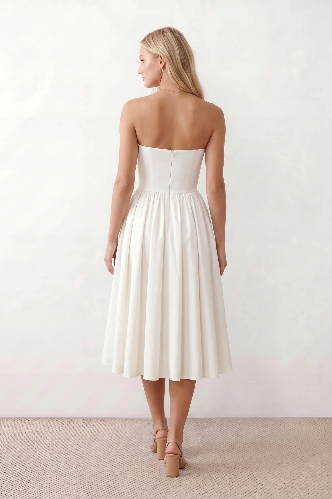 Women's strapless corset midi dress with a structured sweetheart neckline, boned bodice, pintuck basque waist and full pleated A-line skirt, elegant wedding guest and occasion dress.
