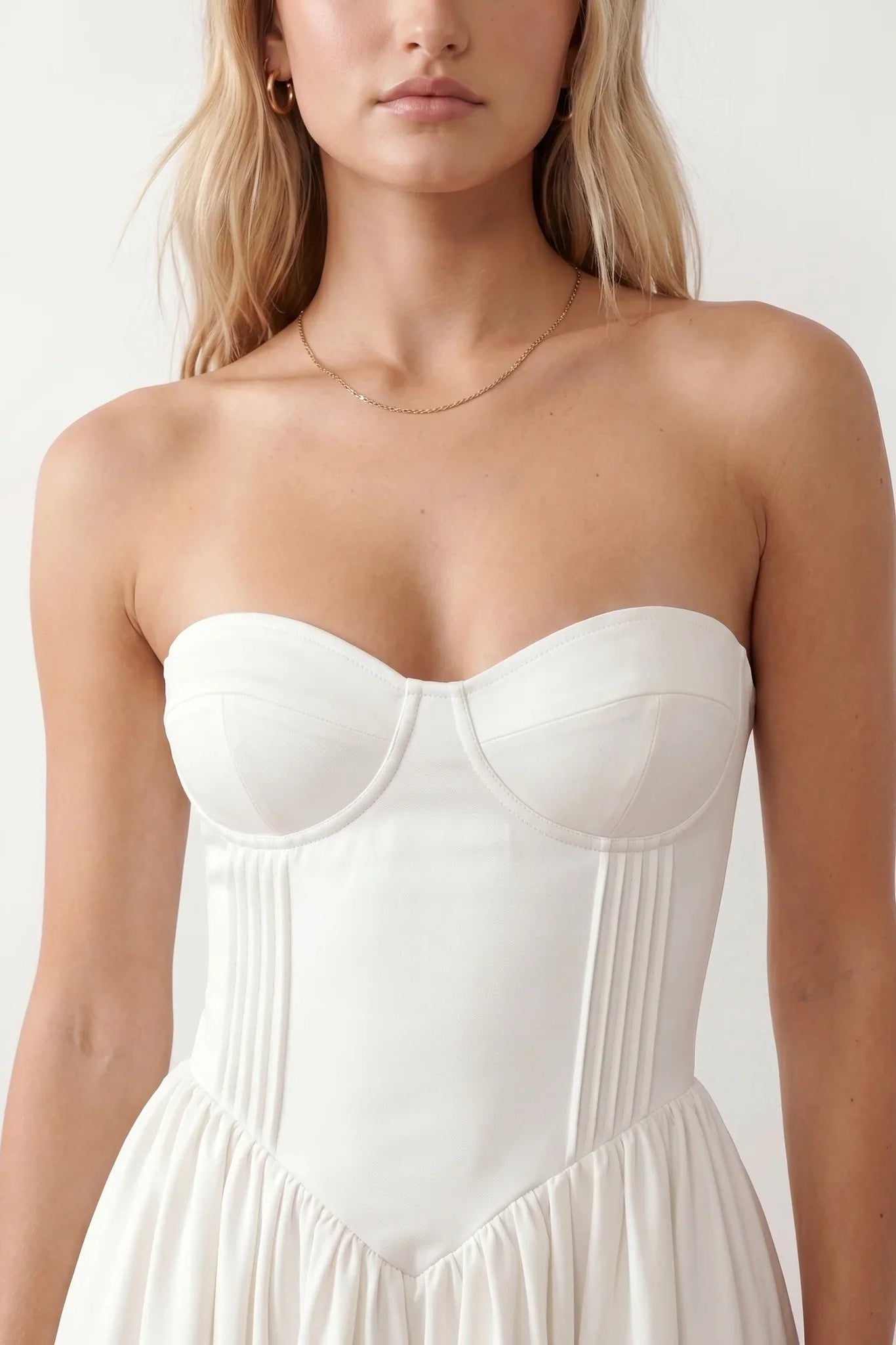Women's strapless corset midi dress with a structured sweetheart neckline, boned bodice, pintuck basque waist and full pleated A-line skirt, elegant wedding guest and occasion dress.