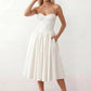 Women's strapless corset midi dress with a structured sweetheart neckline, boned bodice, pintuck basque waist and full pleated A-line skirt, elegant wedding guest and occasion dress.