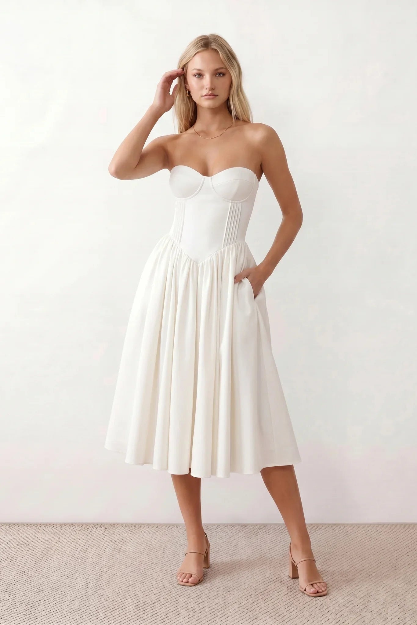 Women's strapless corset midi dress with a structured sweetheart neckline, boned bodice, pintuck basque waist and full pleated A-line skirt, elegant wedding guest and occasion dress.