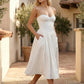 Women's strapless corset midi dress with a structured sweetheart neckline, boned bodice, pintuck basque waist and full pleated A-line skirt, elegant wedding guest and occasion dress.
