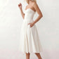 Women's strapless corset midi dress with a structured sweetheart neckline, boned bodice, pintuck basque waist and full pleated A-line skirt, elegant wedding guest and occasion dress.