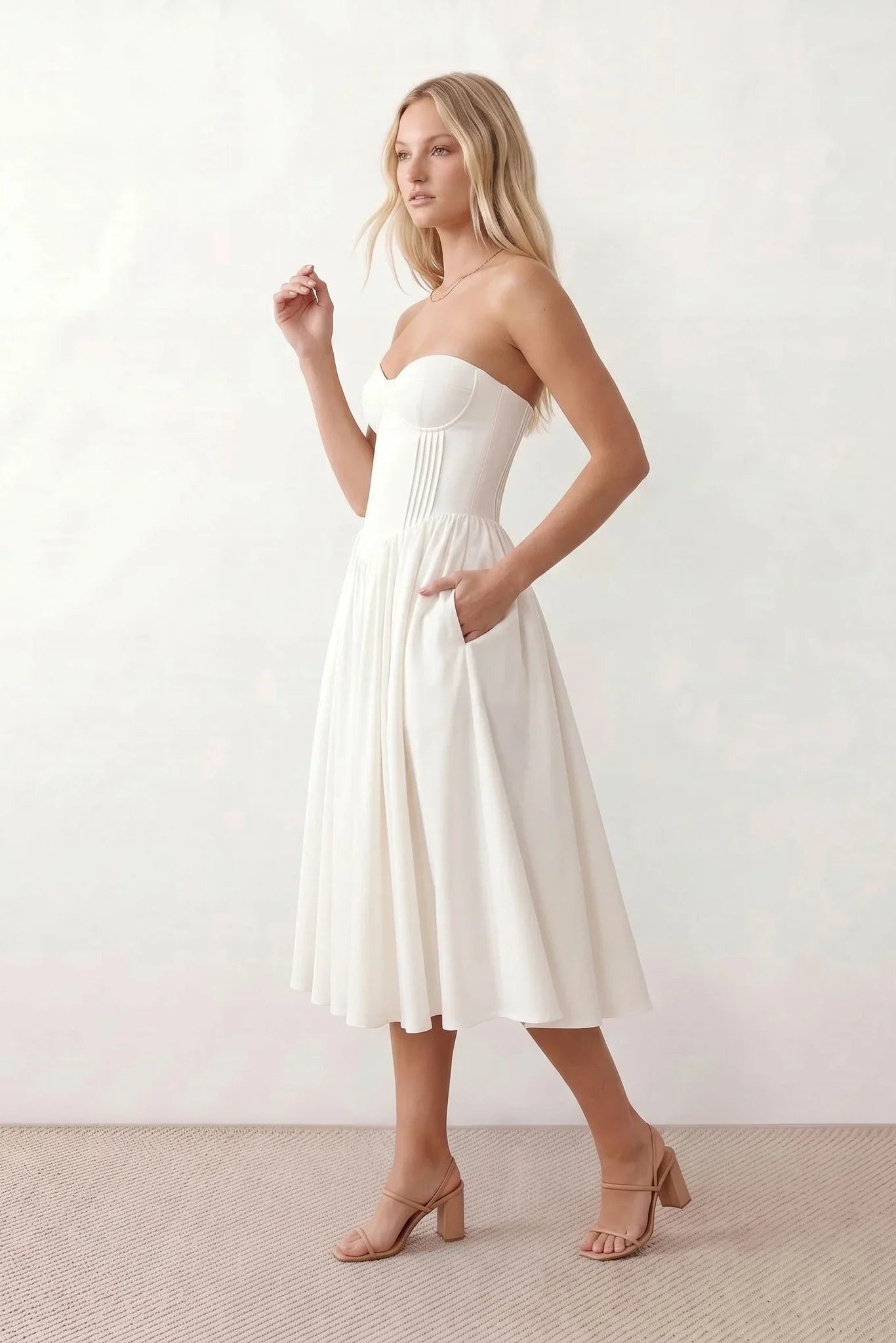 Women's strapless corset midi dress with a structured sweetheart neckline, boned bodice, pintuck basque waist and full pleated A-line skirt, elegant wedding guest and occasion dress.