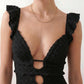 Woman wearing the crochet mermaid maxi dress featuring an intricate crochet knit, plunging V-neckline, ruffled shoulder straps, keyhole waist cut-out, adjustable lace-up open back, scalloped hem, and a figure-hugging maxi silhouette, ideal for weddings, cocktail parties, and elegant evening occasions.
