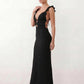 Woman wearing the crochet mermaid maxi dress featuring an intricate crochet knit, plunging V-neckline, ruffled shoulder straps, keyhole waist cut-out, adjustable lace-up open back, scalloped hem, and a figure-hugging maxi silhouette, ideal for weddings, cocktail parties, and elegant evening occasions.