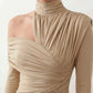 Woman wearing the Asymmetric Neck Open Back Midi Dress featuring an asymmetric mock-neck halter, off-shoulder ruched detailing, long fitted sleeves, an elegant open back, fitted midi silhouette and front slit, styled for weddings, cocktail parties and formal occasions.