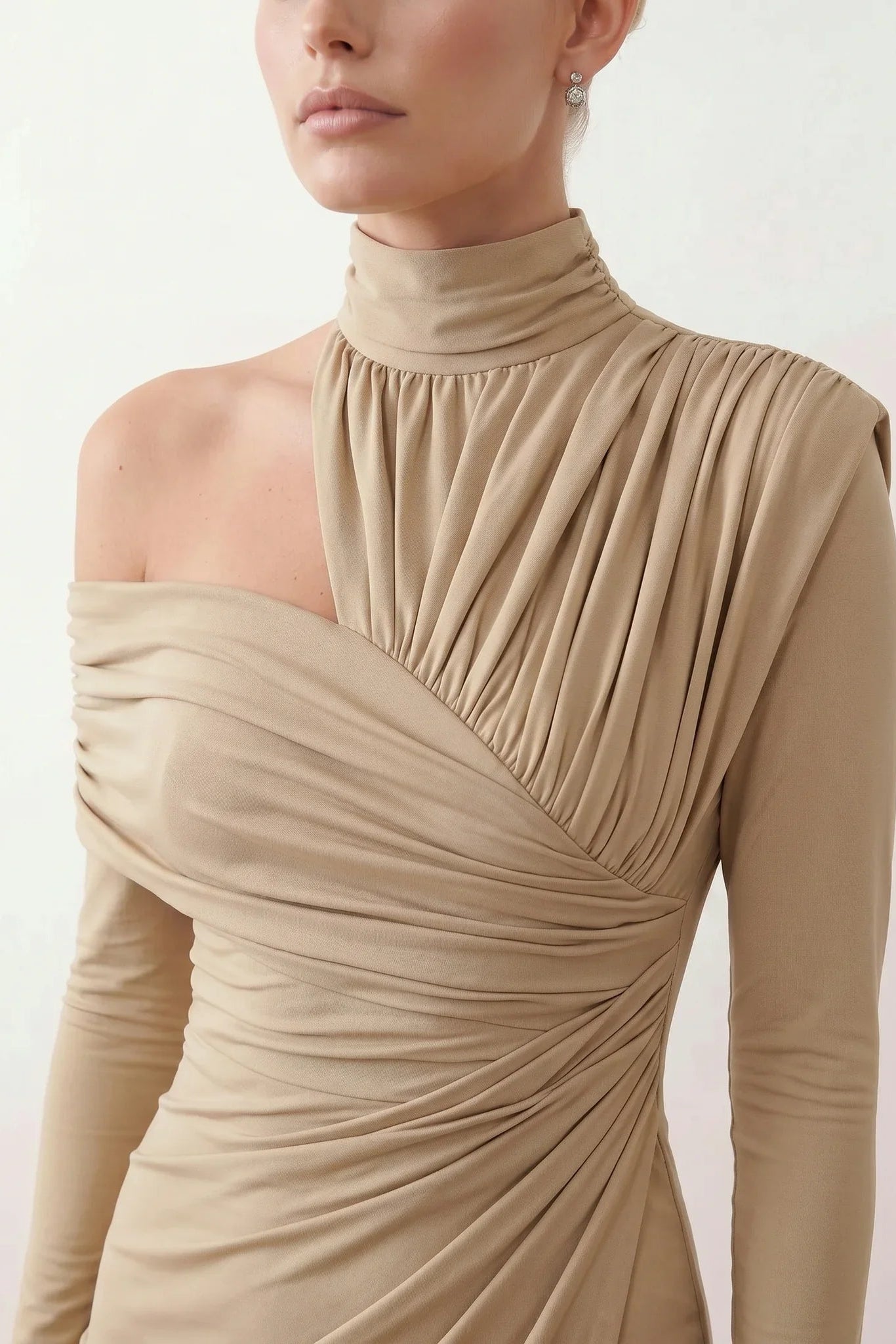 Woman wearing the Asymmetric Neck Open Back Midi Dress featuring an asymmetric mock-neck halter, off-shoulder ruched detailing, long fitted sleeves, an elegant open back, fitted midi silhouette and front slit, styled for weddings, cocktail parties and formal occasions.