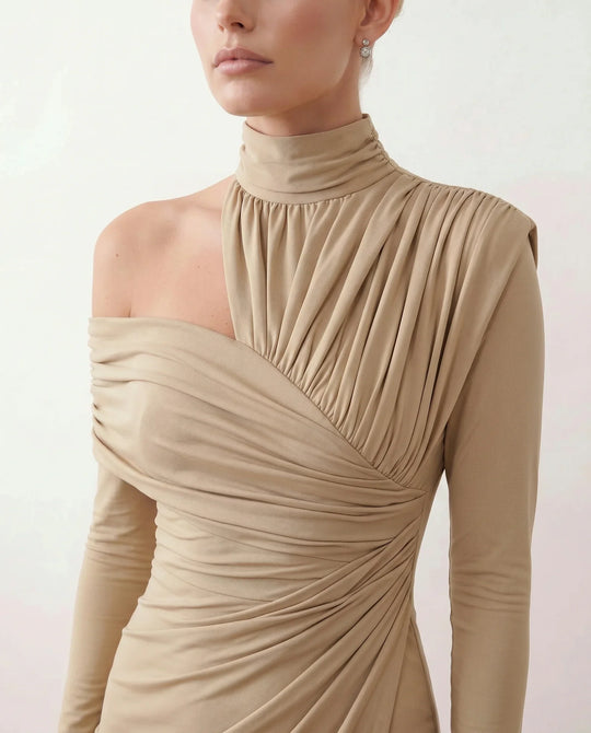 Woman wearing the Felisa Asymmetric Neck Open Back Midi Dress featuring an asymmetric mock-neck halter, off-shoulder ruched detailing, long fitted sleeves, an elegant open back, fitted midi silhouette and front slit, styled for weddings, cocktail parties and formal occasions.