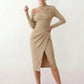 Woman wearing the Asymmetric Neck Open Back Midi Dress featuring an asymmetric mock-neck halter, off-shoulder ruched detailing, long fitted sleeves, an elegant open back, fitted midi silhouette and front slit, styled for weddings, cocktail parties and formal occasions.