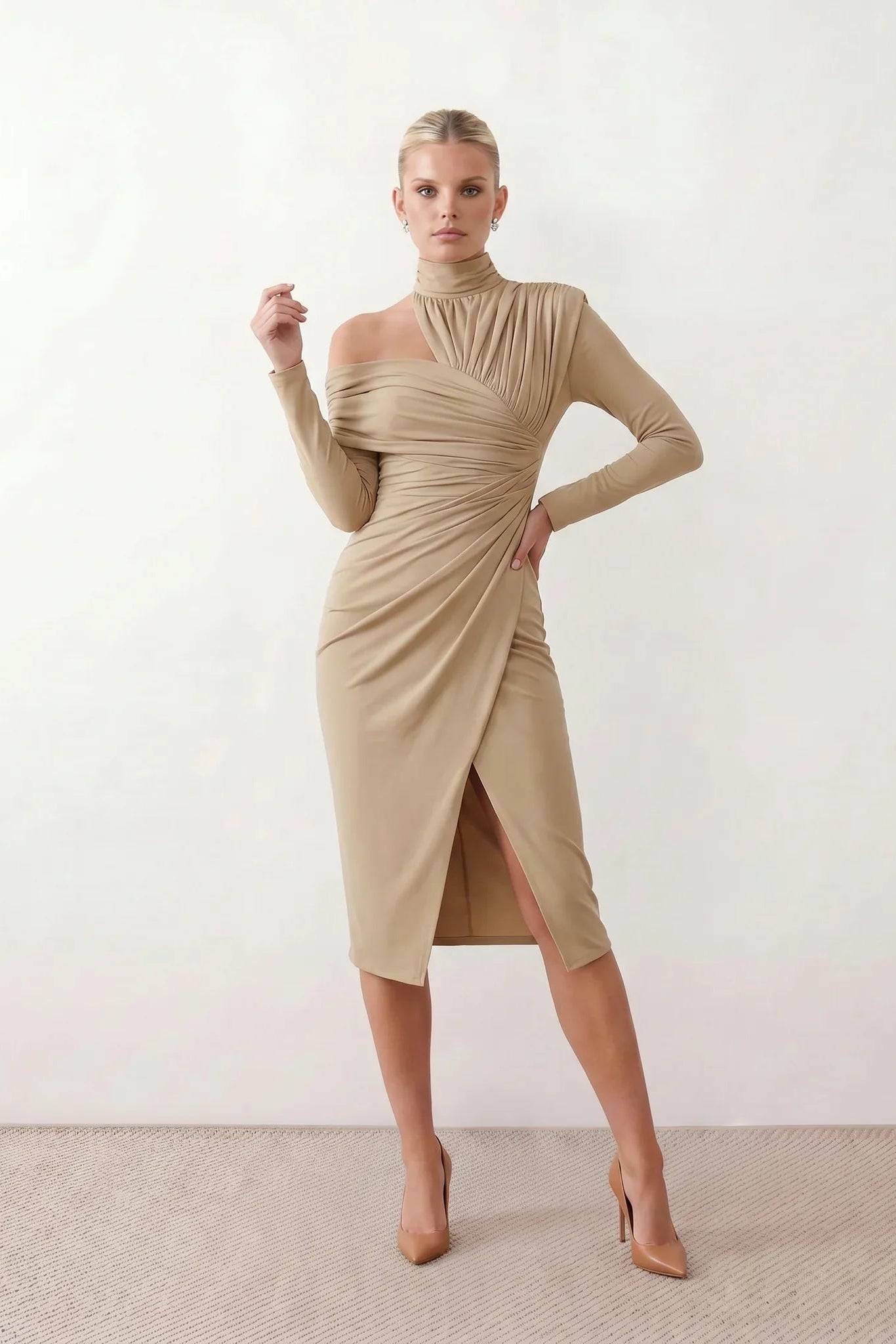 Woman wearing the Asymmetric Neck Open Back Midi Dress featuring an asymmetric mock-neck halter, off-shoulder ruched detailing, long fitted sleeves, an elegant open back, fitted midi silhouette and front slit, styled for weddings, cocktail parties and formal occasions.