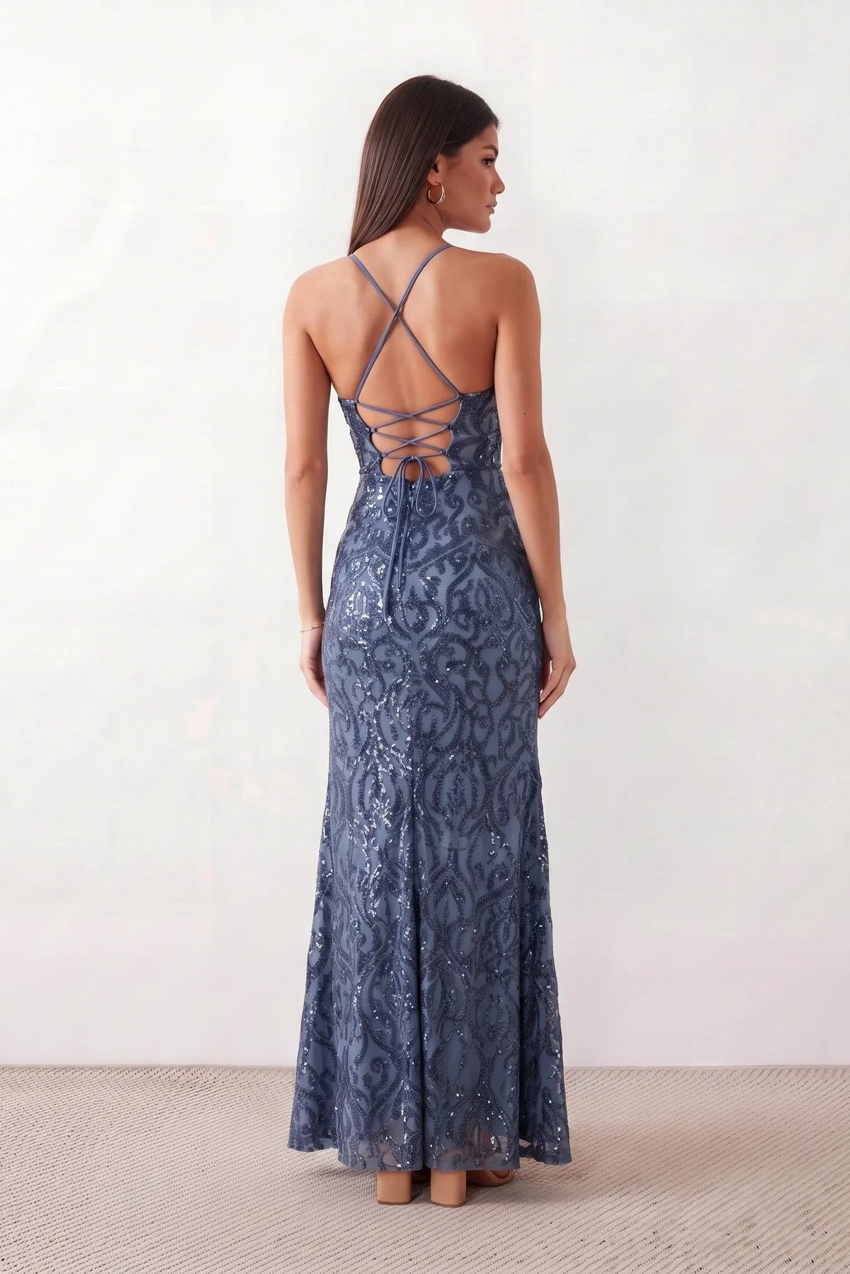 Women's Sequined Spaghetti Strap Maxi Dress in a full-length trumpet silhouette with all-over shimmering sequins, square neckline, delicate spaghetti straps, adjustable lace-up back, and elegant front slit, designed for weddings, proms, black-tie events, and formal evening occasions.