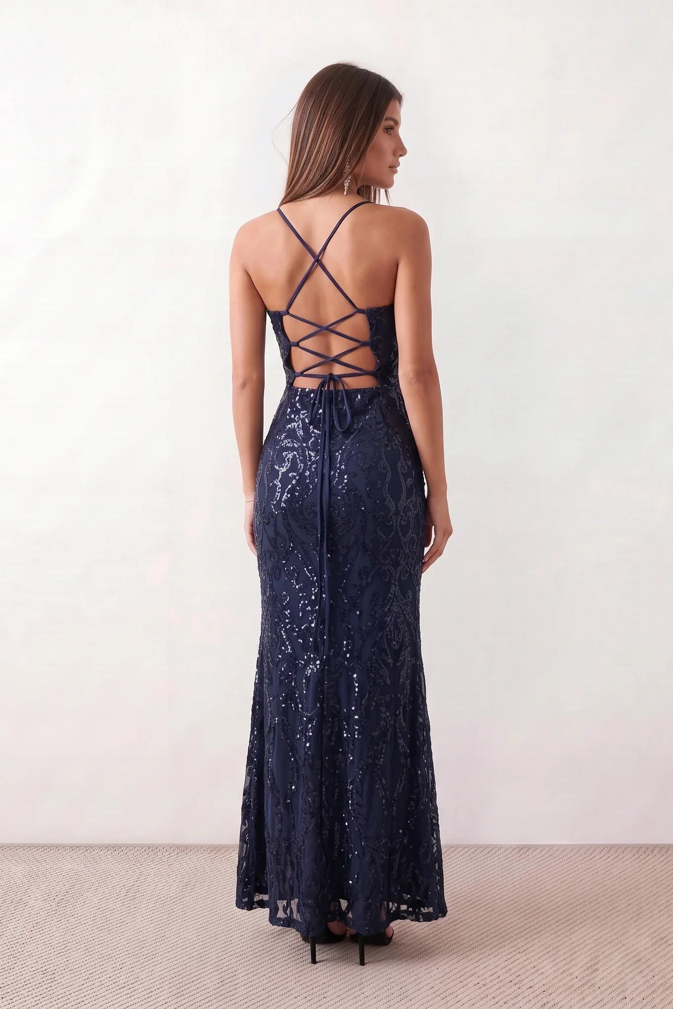Women's Sequined Spaghetti Strap Maxi Dress in a full-length trumpet silhouette with all-over shimmering sequins, square neckline, delicate spaghetti straps, adjustable lace-up back, and elegant front slit, designed for weddings, proms, black-tie events, and formal evening occasions.