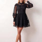 Woman wearing the Lace Openwork Mini Dress featuring intricate lace-inspired openwork, a mandarin collar, decorative front buttons, long sleeves, a fitted waist, and a scalloped mini hem, ideal for weddings, cocktail parties, and elegant occasions.