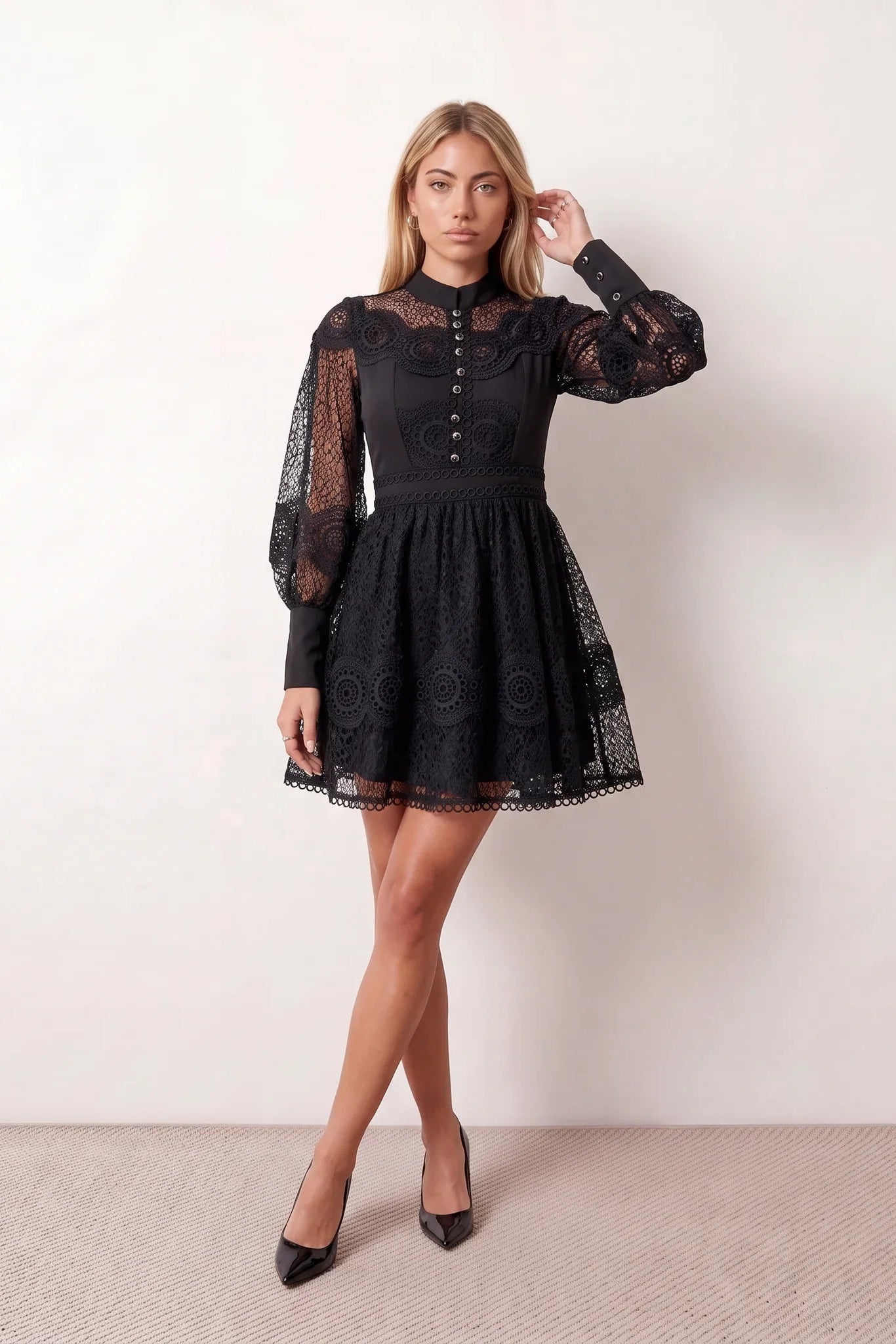 Woman wearing the Lace Openwork Mini Dress featuring intricate lace-inspired openwork, a mandarin collar, decorative front buttons, long sleeves, a fitted waist, and a scalloped mini hem, ideal for weddings, cocktail parties, and elegant occasions.