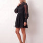 Woman wearing the Lace Openwork Mini Dress featuring intricate lace-inspired openwork, a mandarin collar, decorative front buttons, long sleeves, a fitted waist, and a scalloped mini hem, ideal for weddings, cocktail parties, and elegant occasions.