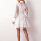 Woman wearing the Lace Openwork Mini Dress featuring intricate lace-inspired openwork, a mandarin collar, decorative front buttons, long sleeves, a fitted waist, and a scalloped mini hem, ideal for weddings, cocktail parties, and elegant occasions.