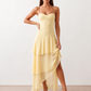 Elsie spaghetti strap sweetheart maxi dress with a structured corset bodice, delicate spaghetti straps, sheer panel detailing, an asymmetric three-tier chiffon skirt with ruffle hem, front slit, and a flowing high-low silhouette, perfect for weddings and special occasions.