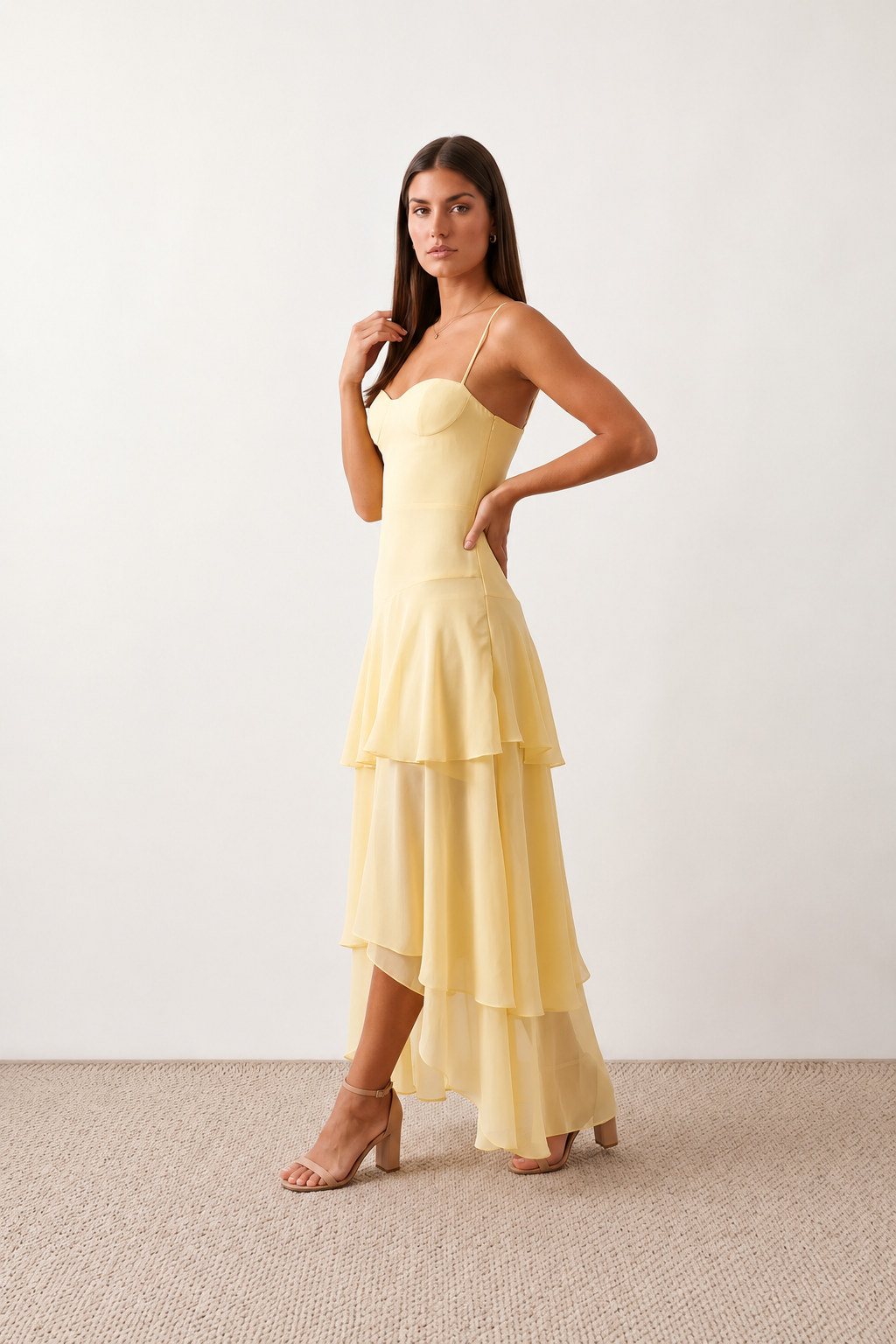 Elsie spaghetti strap sweetheart maxi dress with a structured corset bodice, delicate spaghetti straps, sheer panel detailing, an asymmetric three-tier chiffon skirt with ruffle hem, front slit, and a flowing high-low silhouette, perfect for weddings and special occasions.