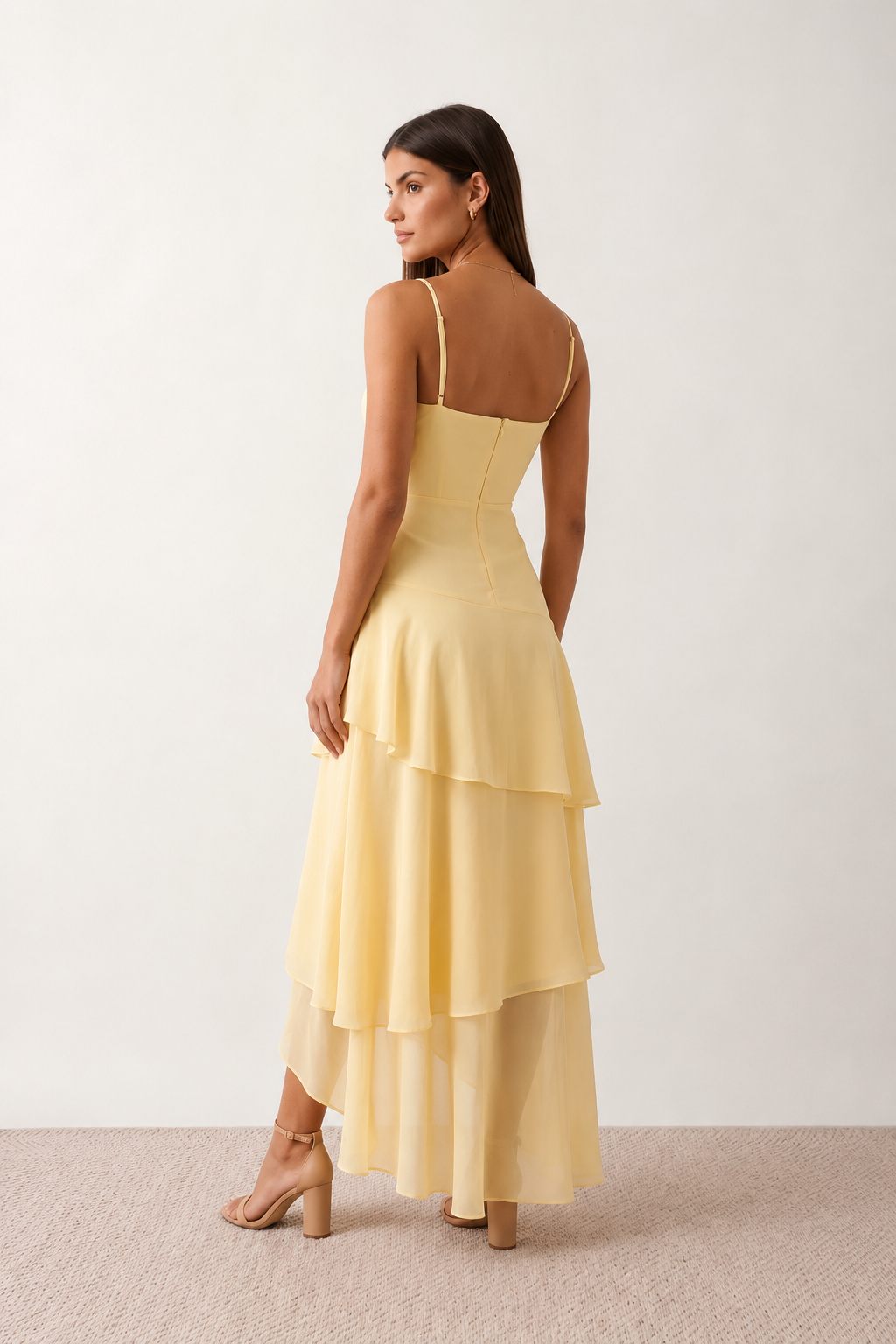Elsie spaghetti strap sweetheart maxi dress with a structured corset bodice, delicate spaghetti straps, sheer panel detailing, an asymmetric three-tier chiffon skirt with ruffle hem, front slit, and a flowing high-low silhouette, perfect for weddings and special occasions.