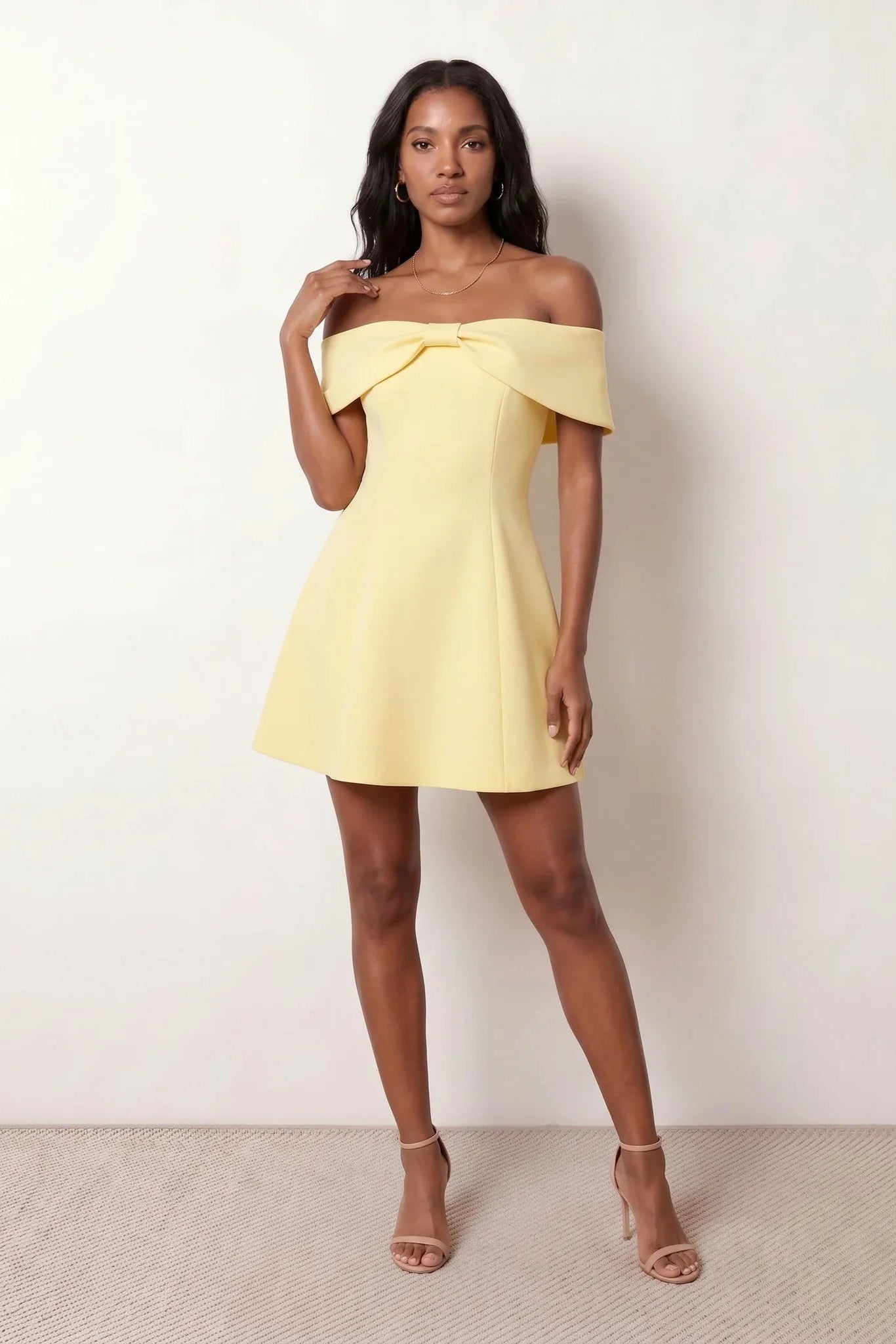 Leni strapless off-shoulder mini dress featuring a Bardot foldover neckline, centered bow detail, twist-front bodice with princess seam shaping, and a flared A-line mini skirt for cocktail parties, weddings, and special occasions.