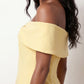Leni strapless off-shoulder mini dress featuring a Bardot foldover neckline, centered bow detail, twist-front bodice with princess seam shaping, and a flared A-line mini skirt for cocktail parties, weddings, and special occasions.