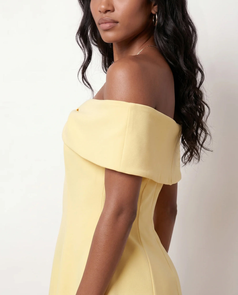 Leni strapless off-shoulder mini dress featuring a Bardot foldover neckline, centered bow detail, twist-front bodice with princess seam shaping, and a flared A-line mini skirt for cocktail parties, weddings, and special occasions.