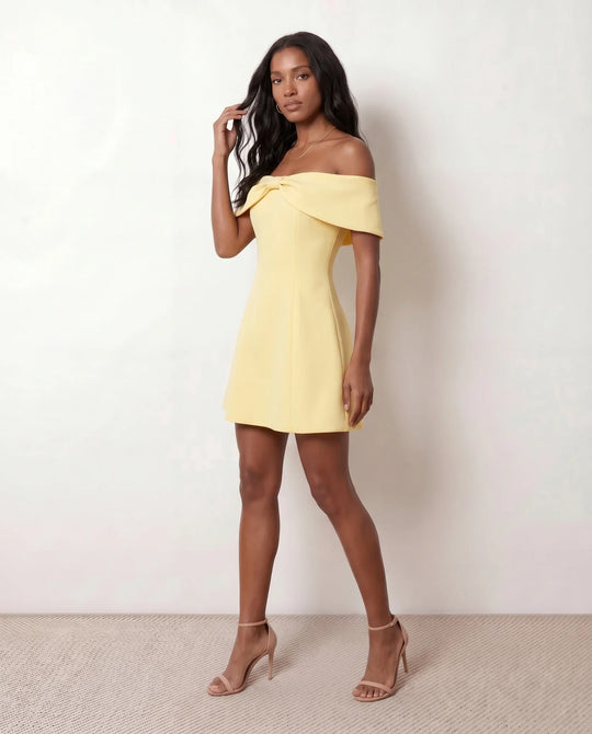 Leni strapless off-shoulder mini dress featuring a Bardot foldover neckline, centered bow detail, twist-front bodice with princess seam shaping, and a flared A-line mini skirt for cocktail parties, weddings, and special occasions.