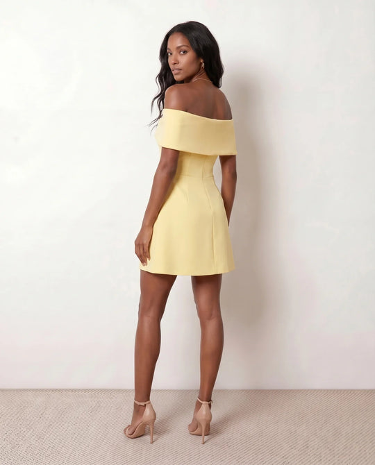 Leni strapless off-shoulder mini dress featuring a Bardot foldover neckline, centered bow detail, twist-front bodice with princess seam shaping, and a flared A-line mini skirt for cocktail parties, weddings, and special occasions.