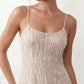 Mariela sequined spaghetti strap mini dress with a sheer sequined bodice, open low back featuring beaded cage straps, layered ostrich feather trim, and a straight-cut mini silhouette for cocktail parties and evening events.