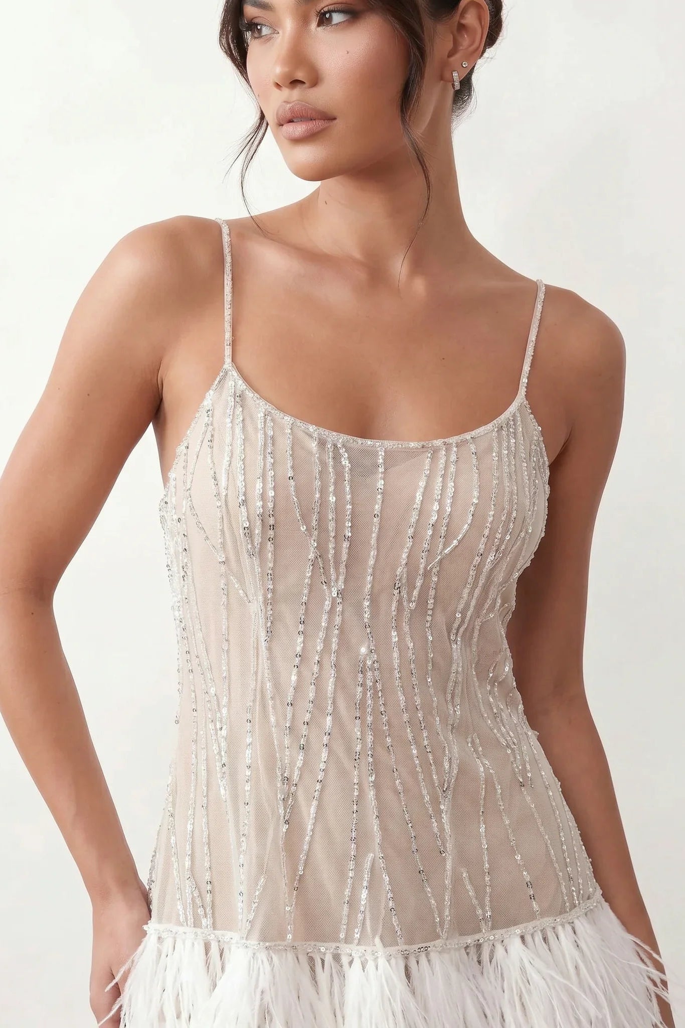Mariela sequined spaghetti strap mini dress with a sheer sequined bodice, open low back featuring beaded cage straps, layered ostrich feather trim, and a straight-cut mini silhouette for cocktail parties and evening events.