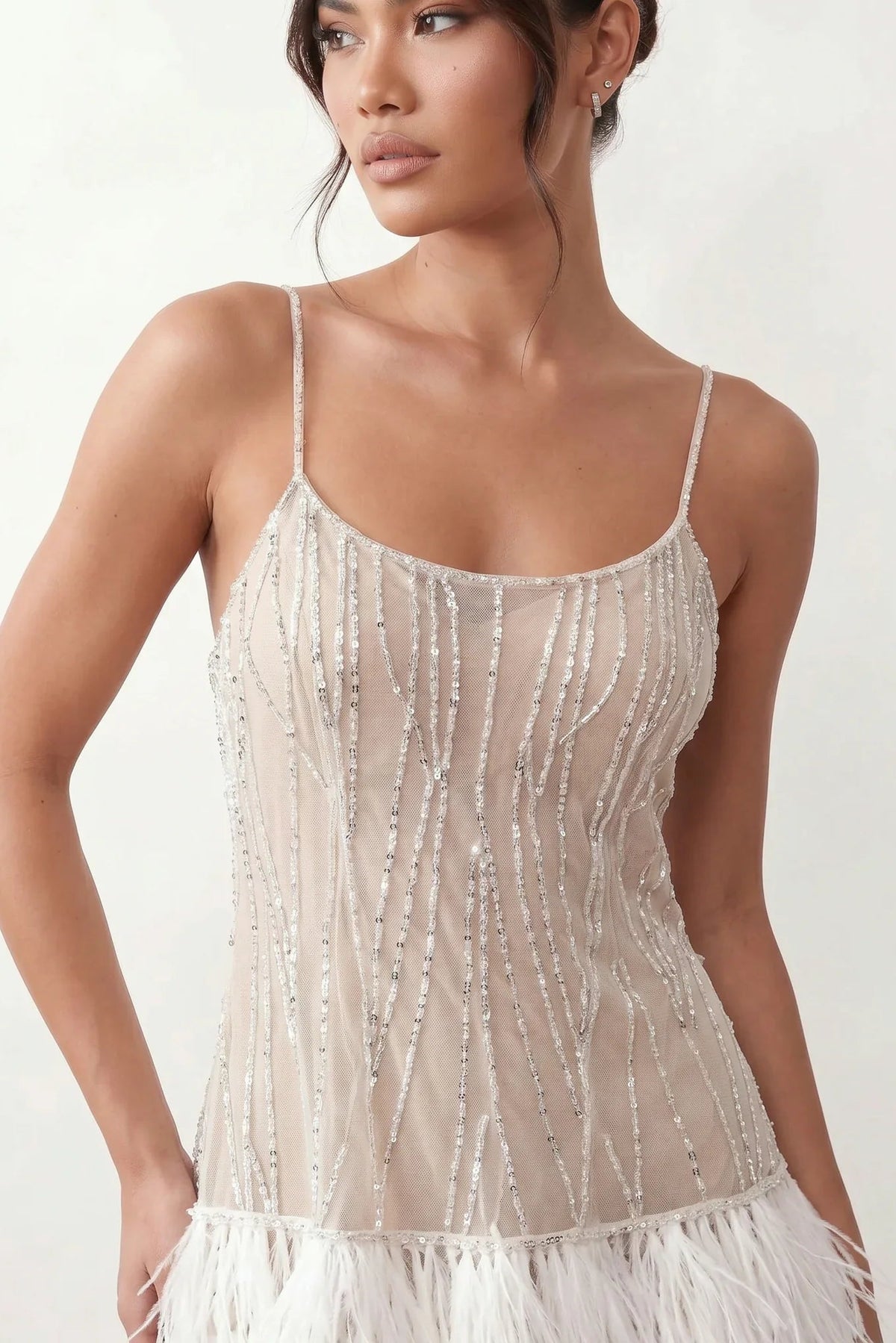 Mariela sequined spaghetti strap mini dress with a sheer sequined bodice, open low back featuring beaded cage straps, layered ostrich feather trim, and a straight-cut mini silhouette for cocktail parties and evening events.