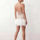 Mariela sequined spaghetti strap mini dress with a sheer sequined bodice, open low back featuring beaded cage straps, layered ostrich feather trim, and a straight-cut mini silhouette for cocktail parties and evening events.