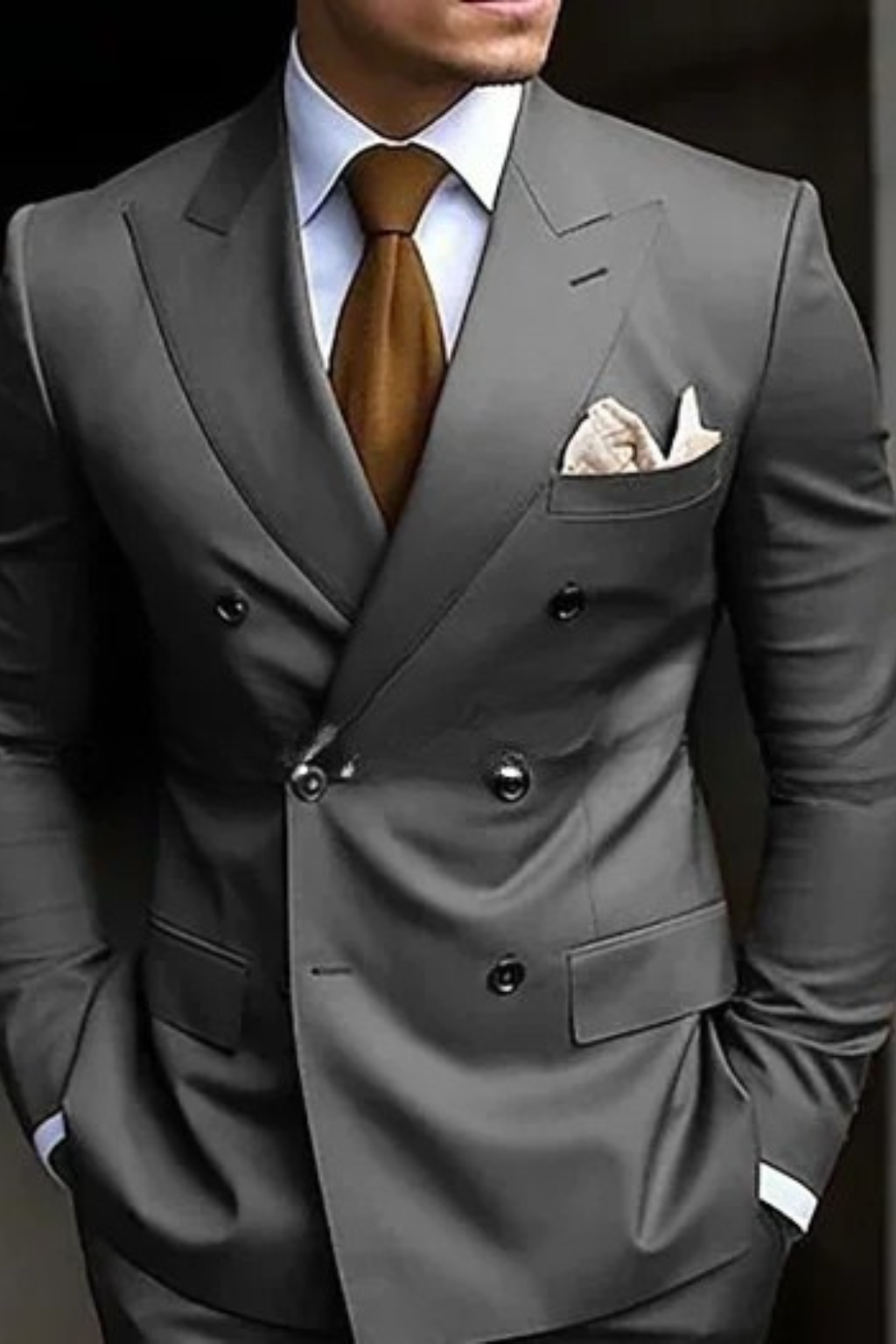 Gray suit with a brown tie and white shirt on a dark background