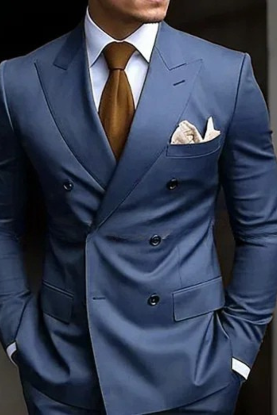Blue suit with a brown tie and pocket square on a dark background