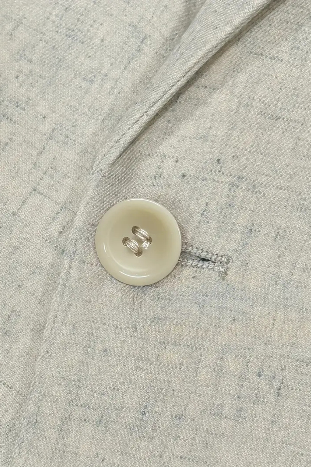 Close-up of a button on a textured fabric surface