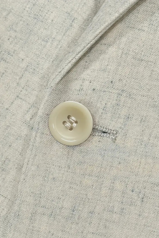 Close-up of a button on a textured fabric surface