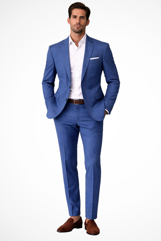 Man wearing a blue suit with a white shirt and brown shoes on a white background