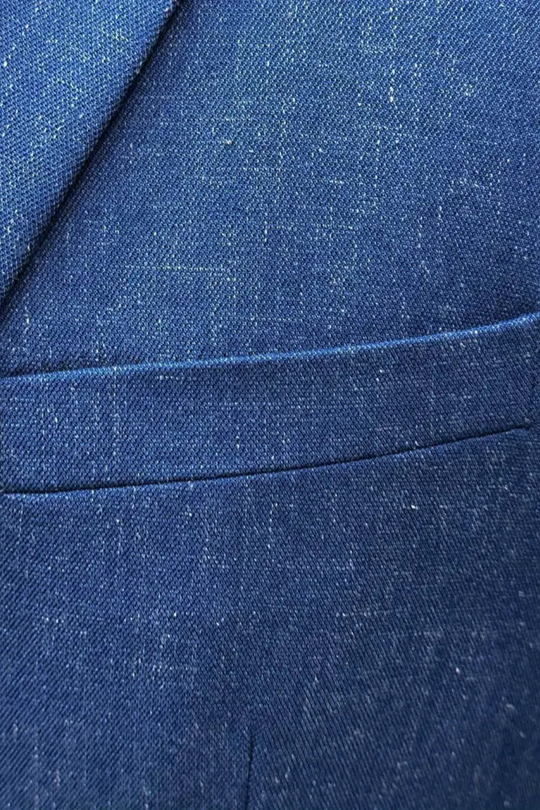 Close-up of blue denim fabric with a pocket