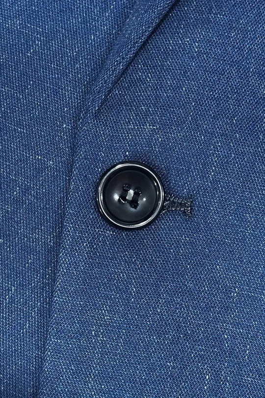 Close-up of a blue textured fabric with a button