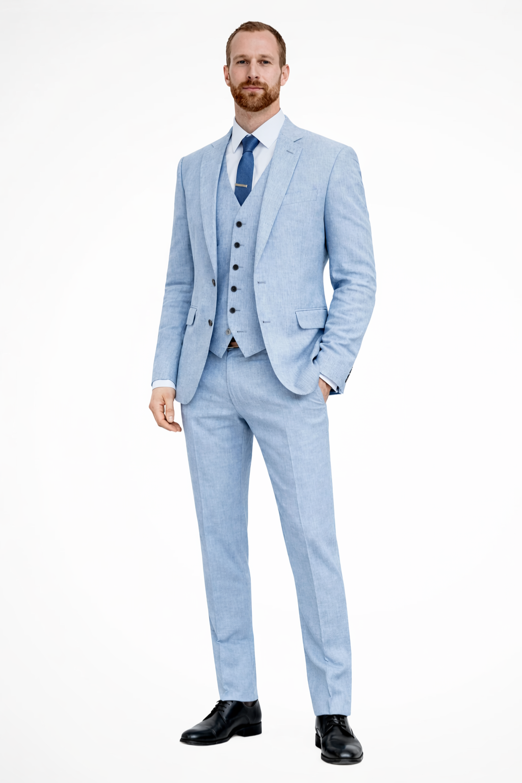 Man wearing a light blue suit with a white shirt and black shoes on a white background