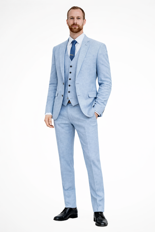 Man wearing a light blue suit with a white shirt and black shoes on a white background