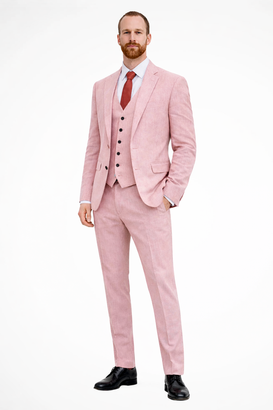 Man wearing a pink suit with a red tie on a white background