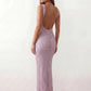 Woman wearing the Mihaela sequined low back maxi dress featuring allover sequin mesh, a square neckline, wide shoulder straps, a low open back, and a fitted floor-length sheath silhouette.
