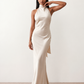 Woman wearing the Winnie satin halter maxi dress featuring a glossy satin finish, halter neckline with tie-back detail, open draped back, and a floor-length relaxed silhouette.